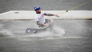 Mężczyzna płynie na desce do wakeboardingu po wodzie